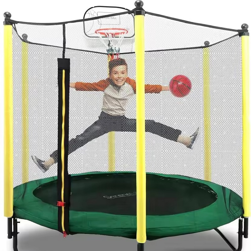 a boy is playing on a trampoline basketball hoop